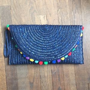 ShiraLeah Blue woven “Pom pom” clutch